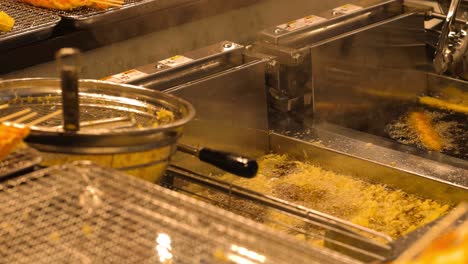 chef preparing tempura in hot oil fryer