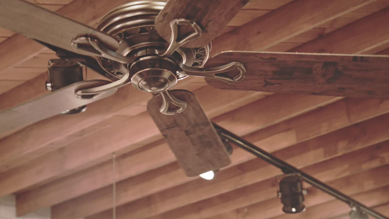 Ceiling fan on wooden roof. Wooden roof background. Cooling fan