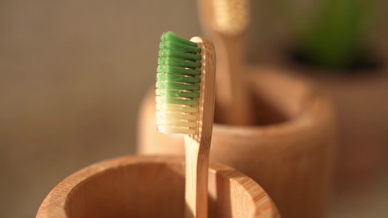 Close-up video of bamboo toothbrushes in holders, highlighting eco-friendly design