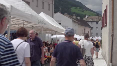 marble and apricot festival - visitors and stands on the main street, laas - lasa, south tyrol, italy (part 1 of 2)