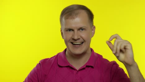 Portrait-of-young-caucasian-man-posing-in-pink-t-shirt.-Happy-handsome-guy-celebrates-and-dances