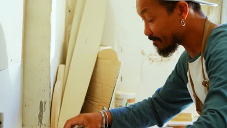 surfboard maker working in workshop 4k