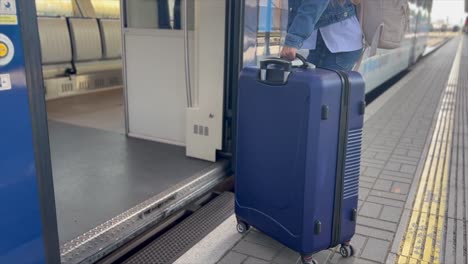 a tourist enters a train car with luggage. train ride