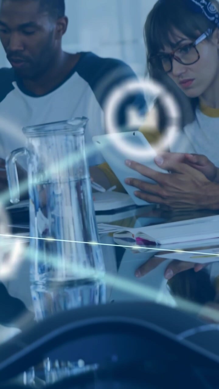 Vertical video: Two colleagues tapping tablets at table, sparking network web growing for business