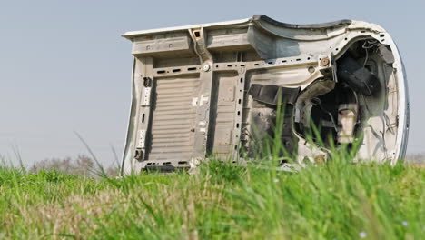 White-Cabin-Of-A-Broken-And-Abandoned-Van-In-The-Grass-Field-On-A-Sunny-Day---medium,-slider-right