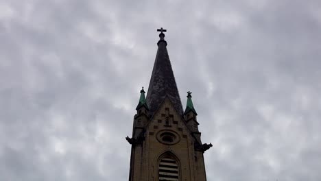 gothic church steeple under dark clouds timelapse