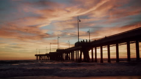 dramatic sunset over a coastal pier