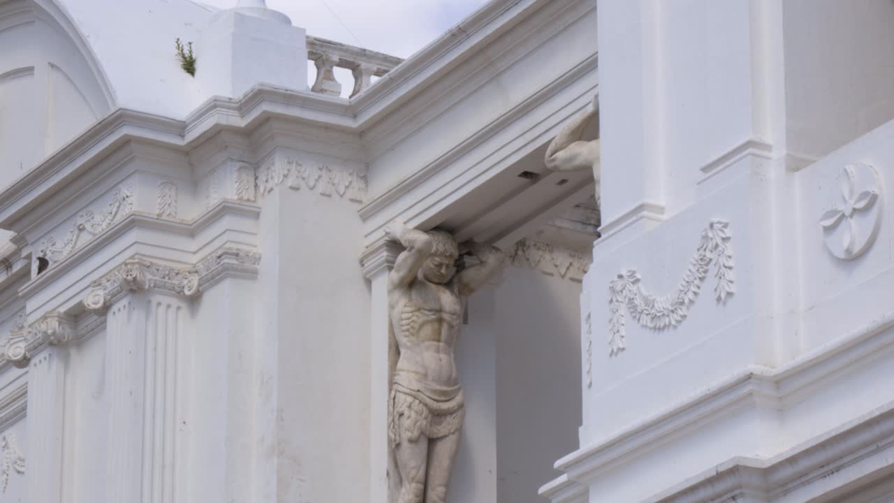 Classical Sculpture on White Building Facade