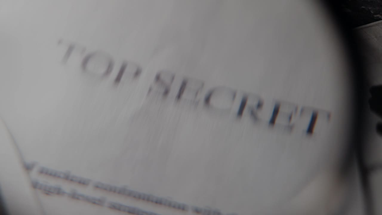 Top secret document close up on office desk with magnifying glass. Military or government spy agency report file with sensitive private information or surveillance intelligence. Archive research