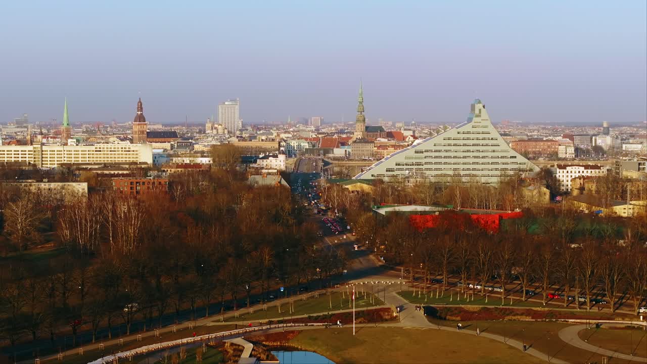 Establishing drone shot of Riga city with autumn foliage and warm golden light