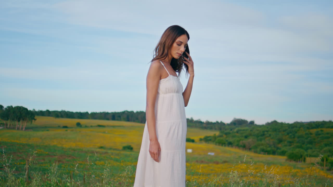 Romantic woman contemplating pasture enjoying nature back view. Girl posing