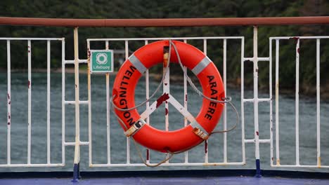 orange lifebuoy on the ferry between new zealand's north and south islands