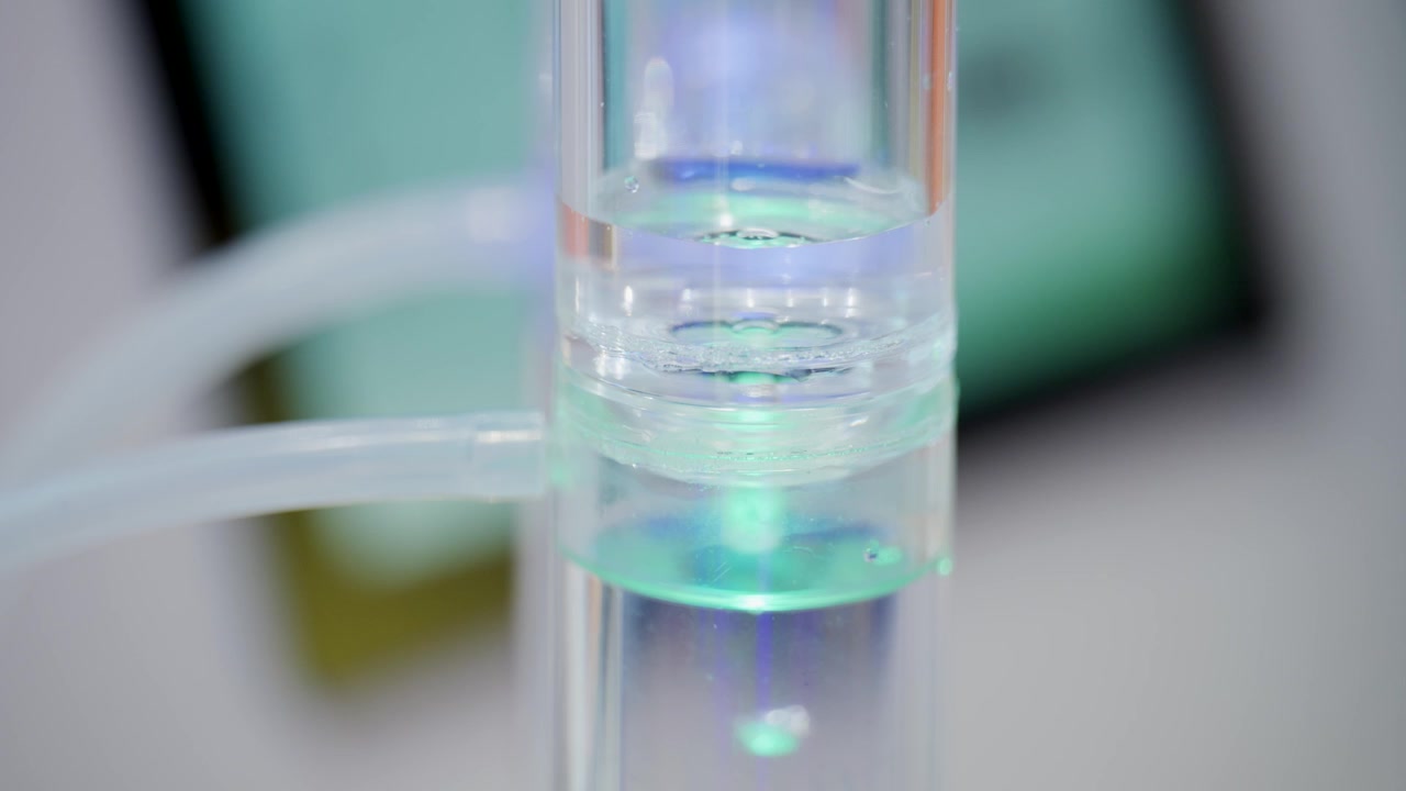 Macro shot of hydrogen gas formation inside transparent laboratory reactor tube during electrolysis process for sustainable energy and clean fuel technology