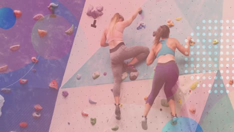 animation of spots over two caucasian women on climbing wall