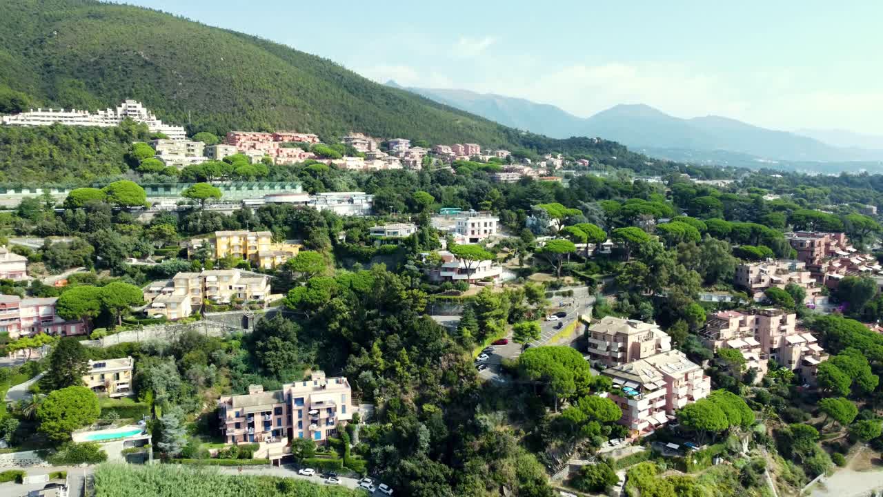 Aerial view of a hillside with houses and trees