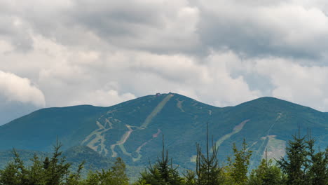 cloud cover passing over ski mountains in the summer time lapse