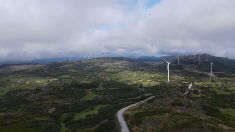 one person on caramulinho viewpoint and eolic wind turbines in background