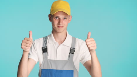 builder in yellow cap giving thumbs up