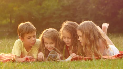 children reading together outdoors