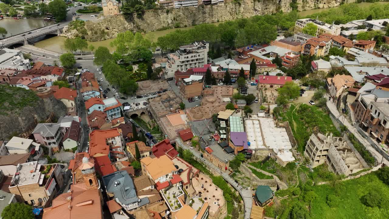 A captivating overhead view of Tbilisi’s old residential neighborhood with orange rooftops and winding narrow streets