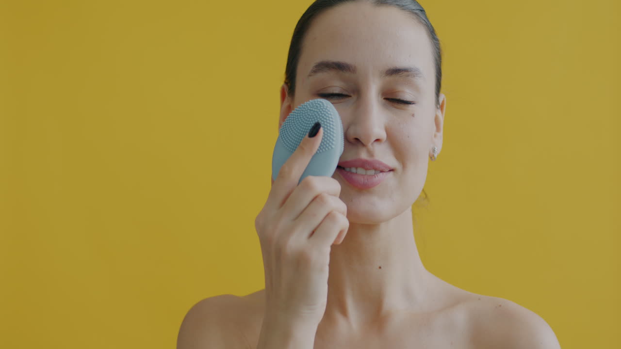 Woman using a facial cleansing brush