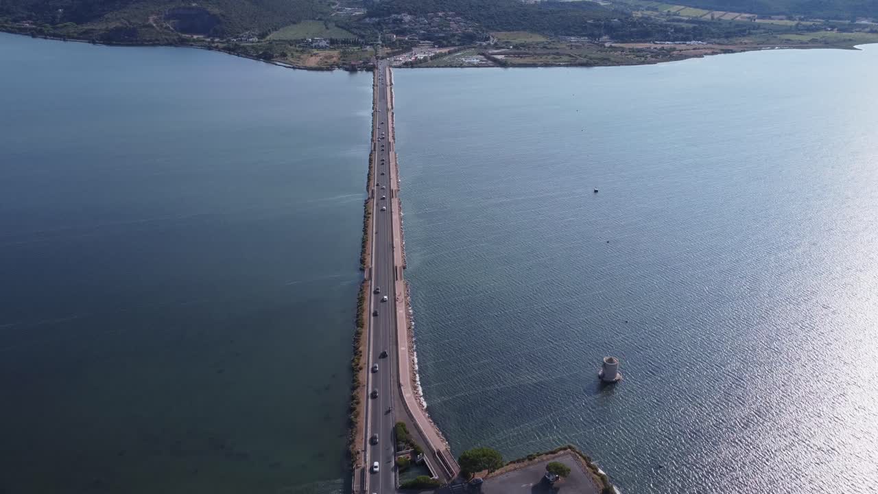 Aerial view of the road stretching across the Orbetello Lagoon in Tuscany—perfect symmetry, tranquil waters, and scenic Italian coastline.