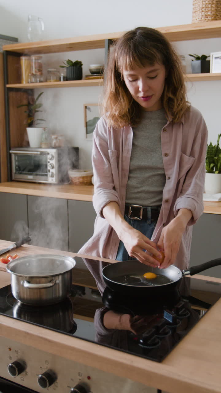 Woman Cooking Eggs in Kitchen