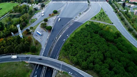 wonderful aerial view with a drone over motorway exits of highway interchange in france. only homes and grass fields around roads. cars and trucks driving on the roads.