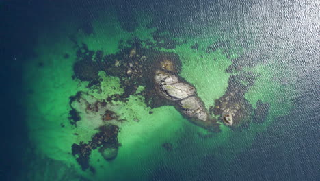 Scenic-Turquoise-Islet-on-Lofoten-Island-in-Reinefjorden-on-a-nice-sunny-day,-Aerial-Birdseye-view