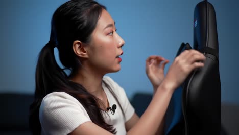 a young woman engages with a gaming chair, showcasing features and design elements in a subtle yet captivating atmosphere