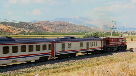 a passenger train travels across a generic landscape in europe russia or central asia