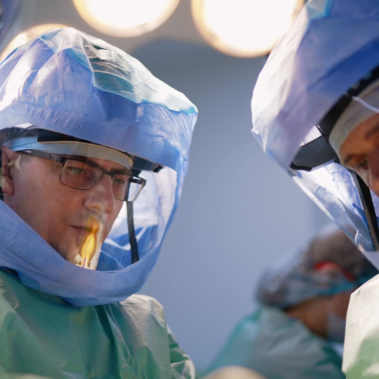 Cirujanos experimentados con cascos protectores se comunican durante la operación. Retratos de profesionales de la cirugía de traumatología en el trabajo