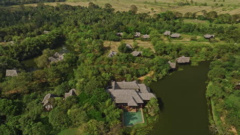 sigiriya sri lanka aerial v4 birds eye view drone flyover and around lakeside retreat resort hotels surrounded by agricultural farmlands and lush tropical forests - shot with mavic 3 cine - april 2023