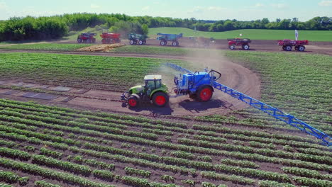 agricultural tractor with spraying trailer fertilizing agricultural field