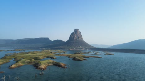 aerial shot of karamchat dam in bihar, with the serene waters and scenic hills in the backdrop.