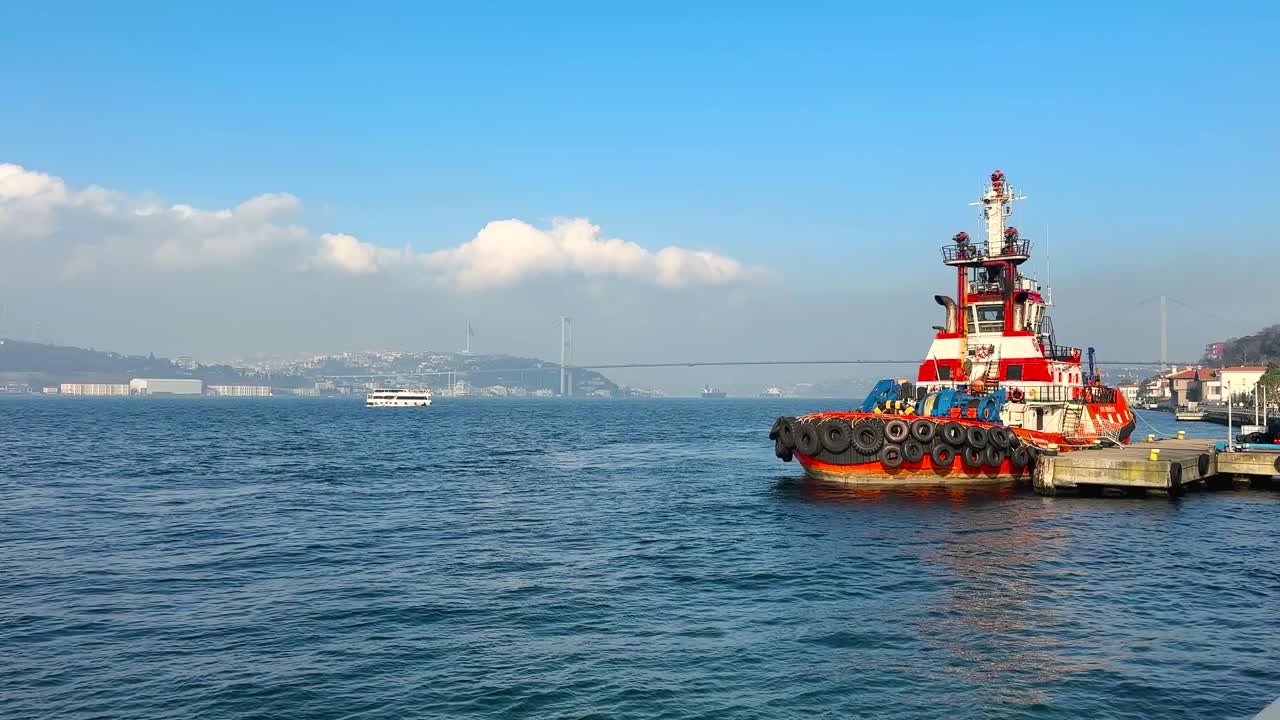 Colorful boat anchored by wooden pier on Bosphorus Strait in Istanbul