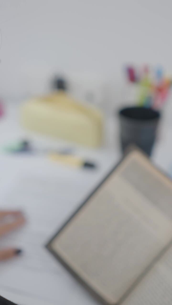 Person Reading a Book at a Desk