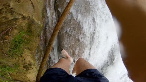 descend waterfall using rope by hand, in chiapas national park hike trip