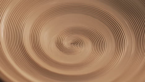 close-up view of clay spinning on a pottery wheel