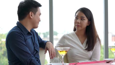 happy romantic couple eating lunch at restaurant