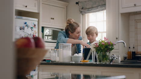 little boy helping mother bake in kitchen mixing ingredients baking cookies preparing recipe at home with mom teaching her son on weekend