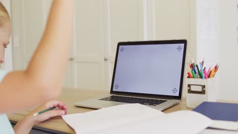 Caucasian-girl-having-a-video-call-on-laptop-with-copy-space-while-doing-homework-at-home