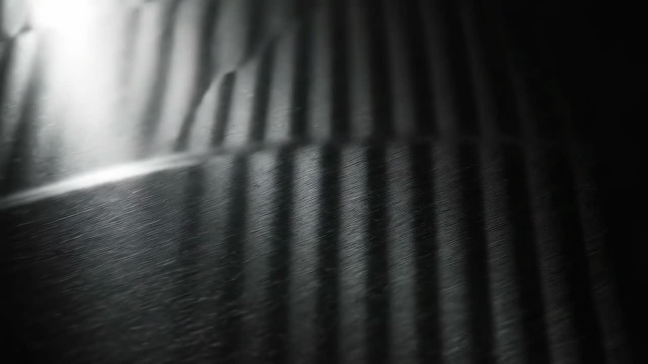Moody video with top-down angle, showcasing dramatic light and shadow patterns on a surface
