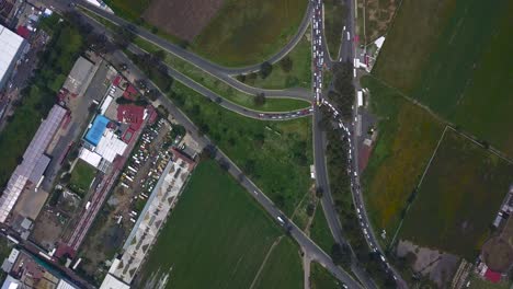 Top-view-of-warehouses-in-the-industrial-park-of-the-town-of-chalco,-Mexico-with-a-view-of-the-roads-and-traffic