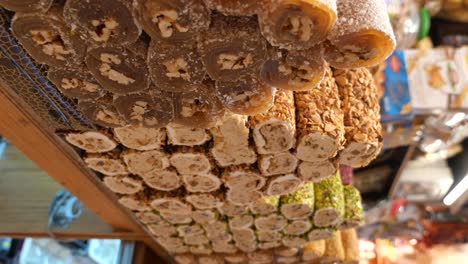 rows of assorted turkish delight with nuts in a market