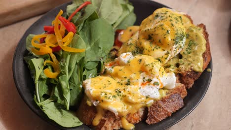 eggs benedict with avocado toast and salad