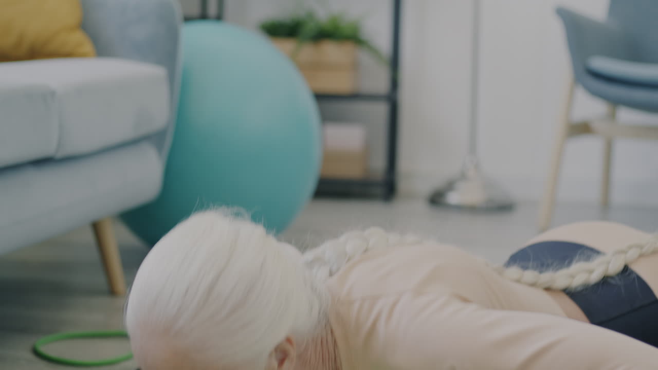 Elderly Woman Doing a Plank Exercise at Home