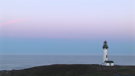 a montage of lighthouse longshots with a pastel sky above a quiet ocean