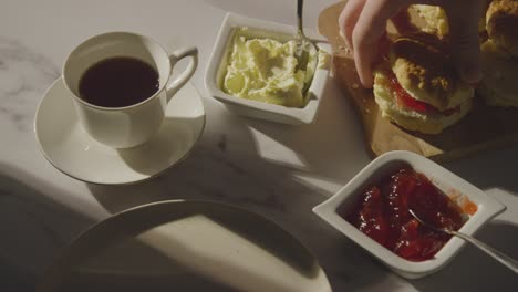 Studio Shot Of Person With Traditional British Afternoon Tea With Scones Cream And Jam 7