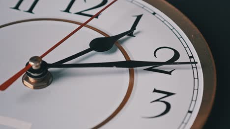 old retro wall clock with moving second hand on white circular dial